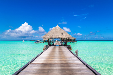 MALDIVES - JUNE 24, 2018: Water Villas (Bungalows) and wooden bridge at Tropical beach in the Maldives at summer eveningのeditorial素材