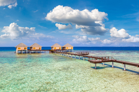 MALDIVES - JUNE 24, 2018: Water Villas (Bungalows) and wooden bridge at Tropical beach in the Maldives at summer dayのeditorial素材