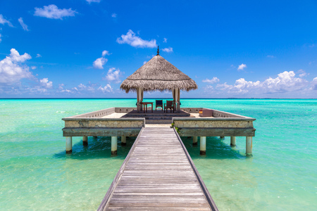 MALDIVES - JUNE 24, 2018: Water Villas (Bungalows) and wooden bridge at Tropical beach in the Maldives at summer dayのeditorial素材