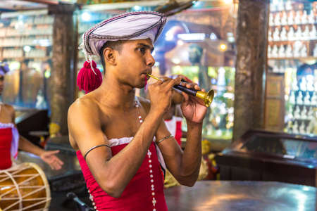 COLOMBO, SRI LANKA - FEBRUARY 11, 2020: Traditional musician in Gangaramaya Buddhist Temple in Colombo, Sri Lankaのeditorial素材