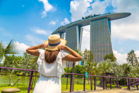 SINGAPORE, SINGAPORE - FEBRUARY 26, 2020: Woman traveler looking at Marina Bay Sands Hotel  in Singaporeのeditorial素材