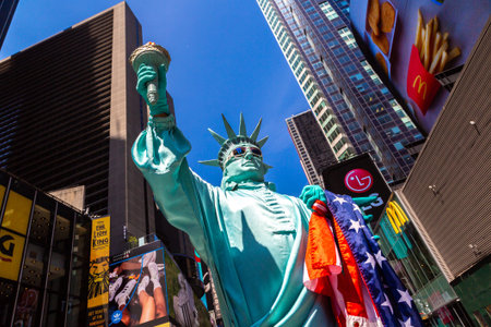 NEW YORK CITY, USA - MARCH 15, 2020: Street artist dressed up as Statue of Liberty in Times Square,...