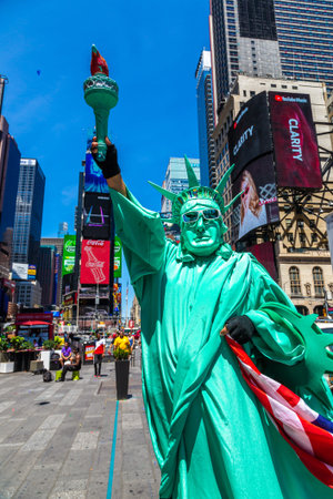 NEW YORK CITY, USA - MARCH 15, 2020: Street artist dressed up as Statue of Liberty in Times Square, New York City, USAのeditorial素材