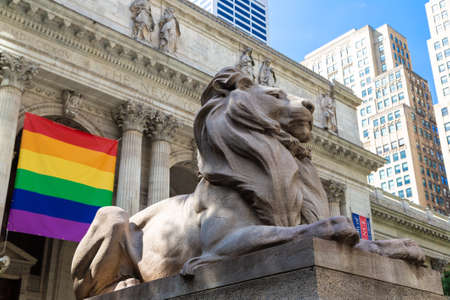 NEW YORK CITY, USA - MARCH 15, 2020: Facade of the New York Public Library and rainbow lgbt flag, New York City, USAのeditorial素材