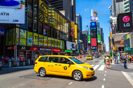 NEW YORK CITY, USA - MARCH 15, 2020: Yellow taxi on Times Square is a symbol of New York City, USA
