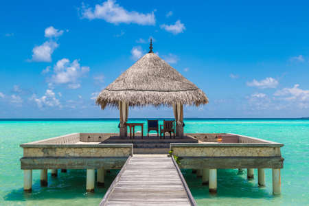 MALDIVES - JUNE 24, 2018: Water Villas (Bungalows) and wooden bridge at Tropical beach in the Maldives at summer dayのeditorial素材