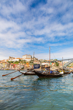 LISBON, PORTUGAL - JULY 30, 2014: Porto and old  traditional boats with wine barrels in Portugal in...