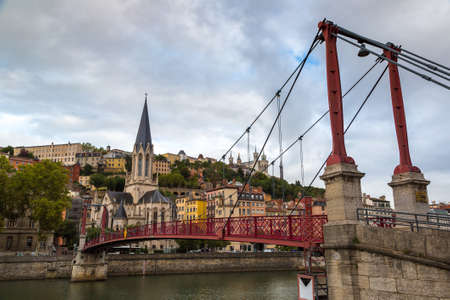 LYON, FRANCE - JULY 25, 2017: Pedestrian Saint Georges footbridge and the Saint Georges church in Lyon, France in a beautiful summer dayのeditorial素材
