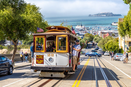 SAN FRANCISCO, USA - MARCH 29, 2020: The Cable car tram and Alcatraz prison island on a background...