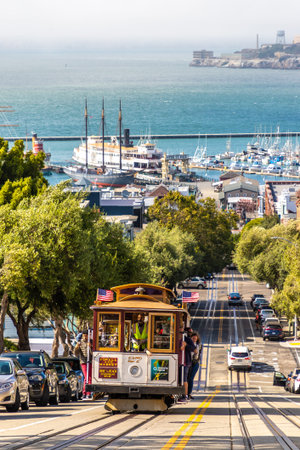 SAN FRANCISCO, USA - MARCH 29, 2020: The Cable car tram and Alcatraz prison island on a background in San Francisco, California, USAのeditorial素材