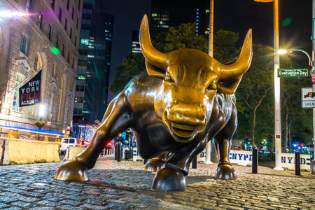 NEW YORK CITY, USA - MARCH 15, 2020: Charging Bull sculpture in New York City at night, USAのeditorial素材