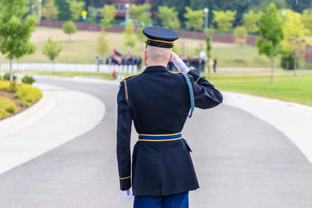WASHINGTON DC, USA - MARCH 29, 2020: US soldier giving salute at Military burial ceremony in Arlington national cemetery in Washington DC, USAのeditorial素材