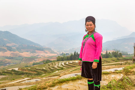 SAPA, VIETNAM - JUNE 19, 2018: Woman wearing traditional clothes at Terraced rice field in Sapa, Lao...