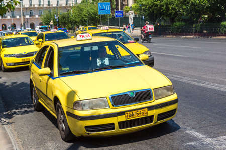 ATHENS, GREECE - JULY 19, 2015: Yellow taxi in Athens in a beautiful summer day in Athens, Greece on July 19, 2015のeditorial素材