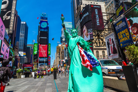 NEW YORK CITY, USA - MARCH 15, 2020: Street artist dressed up as Statue of Liberty in Times Square,...