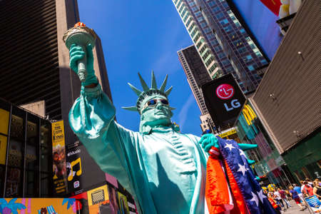 NEW YORK CITY, USA - MARCH 15, 2020: Street artist dressed up as Statue of Liberty in Times Square, New York City, USAのeditorial素材