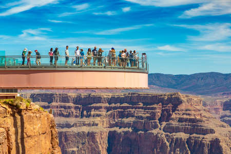 ARIZONA, USA - MARCH 29, 2020: Tourist enjoying the view at Grand Canyon Skywalk observation point at Grand Canyon West Rim in a sunny day, Arizona, USAのeditorial素材