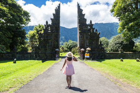 Woman traveler at  Bali Handara Gate in Bali, Indonesia in a sunny dayの写真素材