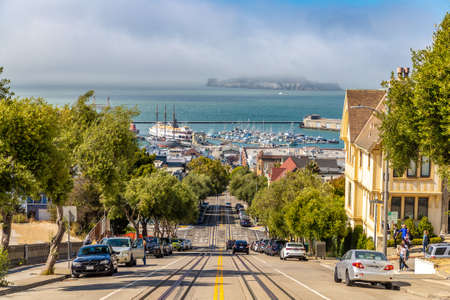 SAN FRANCISCO, USA - MARCH 29, 2020: The Cable car road and Alcatraz prison island on a background in San Francisco, California, USAのeditorial素材