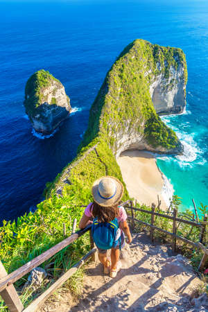 Woman traveler at  viewpoint at Kelingking Beach in Nusa Penida island, Bali, Indonesiaの写真素材