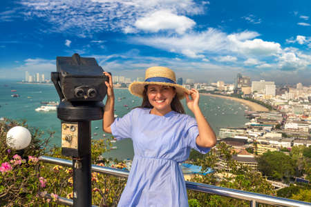 Woman traveler and binoculars at 
Panoramic aerial view of Pattaya Gulf, Thailand in a summer dayの写真素材
