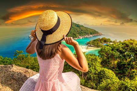 Woman traveler wearing pink dress and straw hat at Nang Yuan Island, Koh Tao, Thailand in a summer dayの写真素材