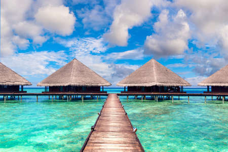Water Villas (Bungalows) and wooden bridge at Tropical beach in the Maldives at summer dayのeditorial素材