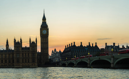 The Big Ben, the Houses of Parliament and Westminster bridge in London in a beautiful summer night,...