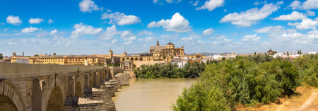 The Great Mosque (Mezquita Cathedral) and Roman Bridge on Guadalquivir river in Cordoba in a beautiful summer day, Spainの写真素材