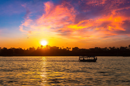 Boat on Nile at sunset in a summer eveningの写真素材
