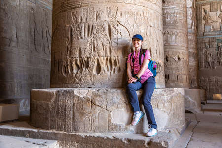 Woman tourist at Dendera temple in a sunny day, Luxor, Egyptの写真素材