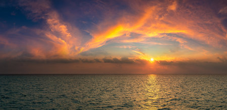 Panorama of  Beautiful tropical sunset over sea in a summer eveningの写真素材