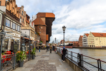 GDANSK, POLAND - SEPTEMBER 7, 2022: Symbol of Gdansk- old port crane in a beautiful old town  in...