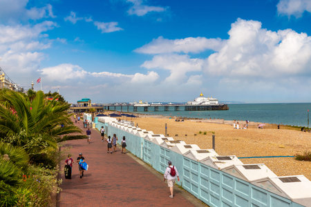EASTBOURNE, UK - JUNE 29, 2022: Eastbourne beach and Beach huts in a sunny summer day, East Sussex,...