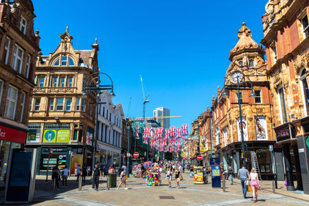 LEEDS, UK - JUNE 16, 2022: British flags at Pedestrian street in Old town in a sunny summer day in...