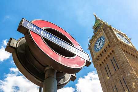LONDON, UK - JUNE 17, 2022: Big Ben and London underground sign outdoor in a sunny summer day in...