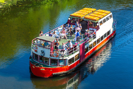 DURHAM, UK - JUNE 28, 2022: Tourist river cruise on the river Wear in Durham in a summer sunny day,...