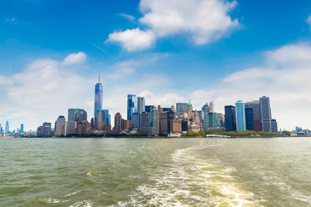 Cruise wash foam in Hudson river and Panoramic view of Manhattan cityscape in New York City at sunset, NY, USAの写真素材