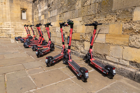 OXFORD, UK - JUNE 11, 2022: Shared electric Scooters for rent by the VOI company in a street in Oxford in a summer day, UKのeditorial素材