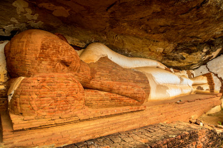 Unfinished reclining Buddha statue located on Pidurangala rock near Lion Rock in Sigiriya in a sunny day, Sri Lankaのeditorial素材