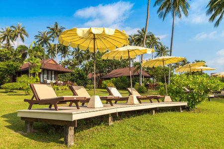 Sunbeds and beach parasol at Luxury tropical resort  in a sunny dayのeditorial素材