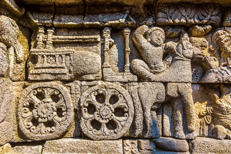 Relief of historical carvings on Buddist temple Borobudur near Yogyakarta city, Central Java, Indonesiaの写真素材