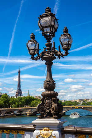 Bronze sculpture on the Bridge Pont Alexandre III and Eiffel Tower in the behind in Paris in a summer day, Franceの写真素材