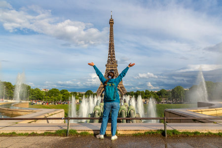 PARIS, FRANCE - Woman traveler at Eiffel Tower and fountains of Trocadero in Paris at sunset, Franceの写真素材