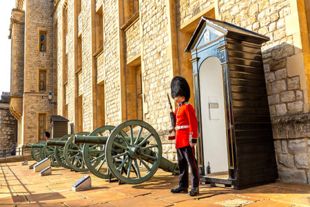 LONDON, UK - SEPTEMBER 26, 2023: Royal Guard in the traditional ceremonial uniform on duty at the Tower of London in a sunny day in London, England, UKのeditorial素材