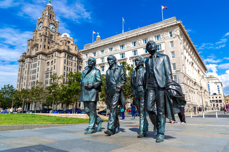LIVERPOOL, UK - AUGUST 16, 2023: The Beatles Statue in Liverpool stands at the Pier Head on the side of Ðºiver Mersey in a sunny day, United Kingdomのeditorial素材