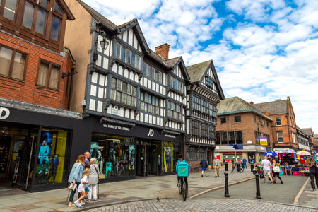 CHESTER, UK - AUGUST 16, 2023: Historical Old town of Chester city and Tudor style half-timbered houses in Chester at sunset, United Kingdomのeditorial素材