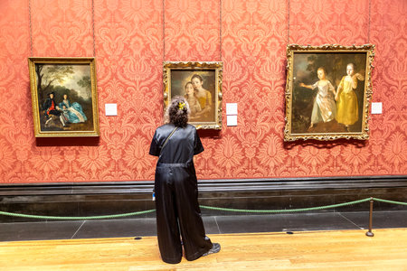 LONDON, UK - SEPTEMBER 8, 2023: Visitor is looking at the oil paintings hanging in The National Gallery in Trafalgar Square in London, UKのeditorial素材