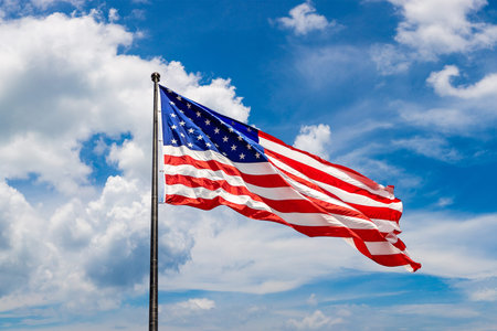 USA flag waving against sky with beautiful cloud