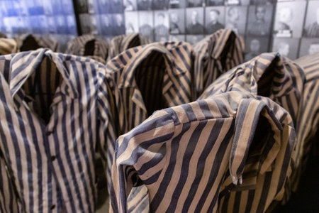OSWIECIM, POLAND - SEPTEMBER 7, 2022: Exhibition with prisoners' clothes in Auschwitz concentration camp in a sunny day, Oswiecim, Polandのeditorial素材